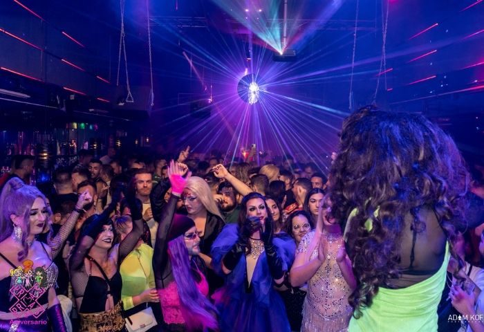 Packed Prima s-Bar gay bar in Madrid with drag queens, laser lights, and disco ball. Gay nightlife travel advice.