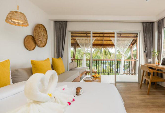 Princess Paradise Koh Phangan beachfront room. Gay hotel with pool view. Swans made of towels on the bed. Tropical vacation.