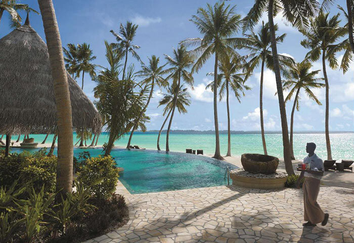 Shangri-La's Villingili Resort & Spa private beachfront. Gay hotel in Maldives with pool, palm trees, and ocean view. Tropical luxury.