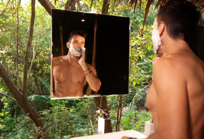 Gay man shaving at Koh Phangan beachfront hotel, Somewhere Only We Know. Private honeymoon destination for gay couples. Thailand travel.