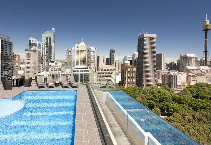 Pullman Sydney Hyde Park's rooftop pool. Best gay hotel in Sydney's Darlinghurst gayborhood. Skyline view with Sydney Tower.