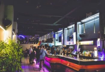 Punto BCN Gay Bar in Barcelona. Interior view of the popular gay bar, showing the bar area, patrons, and modern lighting.