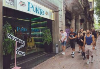 Punto BCN Gay Bar in Barcelona. Gay men outside Punto, a popular bar in Barcelona's gay district. Ravalada Drag Tour sign visible.