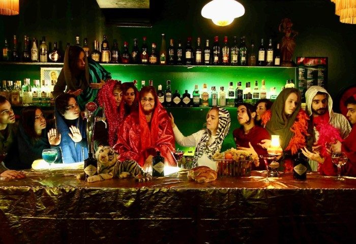 Purex Clube Lisbon: A gay bar scene with patrons in costumes, resembling a modern Last Supper at a bar with bottles and drinks.