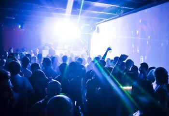 Crowd at QClub Milan, a gay dance club, enjoys music and laser lights. Gay travel advice for nightlife in Italy.
