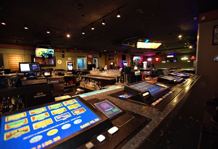 Quadz Video Bar interior in Las Vegas. Gaming machines line the bar top. This gay bar offers a fun and social atmosphere for gay men travelers.
