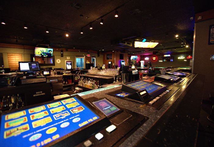 Quadz Video Bar interior in Las Vegas. Gaming machines line the bar top. This gay bar offers a fun and social atmosphere for gay men travelers.