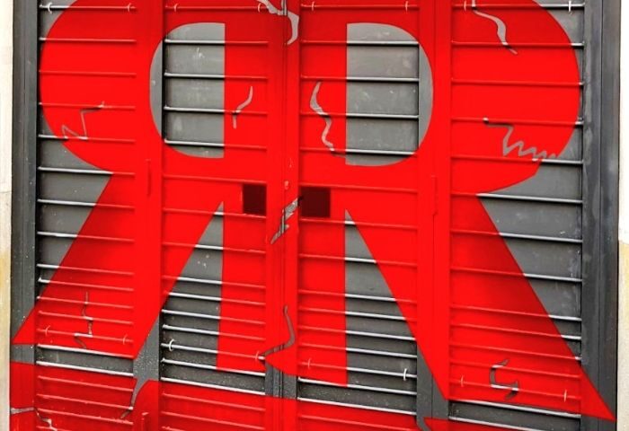 Rectum Gay Cruise Club in Barcelona: Red logo on metal shutters. Gay travel advice for Barcelona's gay scene, a popular gay cruise club.