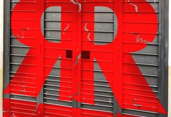 Rectum Gay Cruise Club in Barcelona: Red logo on metal shutters. Gay travel advice for Barcelona's gay scene, a popular gay cruise club.