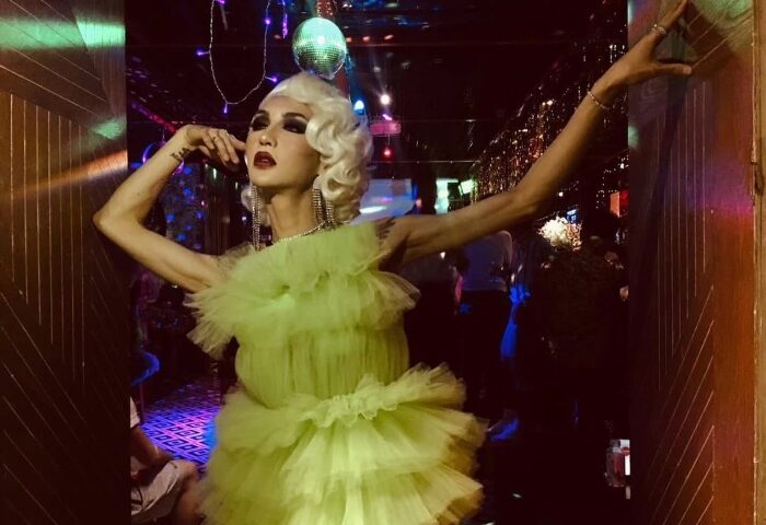 Drag queen at Reddog Bar. Performer in a green dress with disco ball. Gay travel nightlife. Reddog-Bar.jpg.