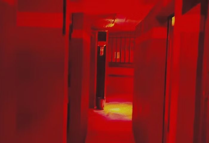 Red-lit corridor inside Reds Cruising Club, a gay cruise club in Gran Canaria. Dark, intimate setting for gay men's travel.