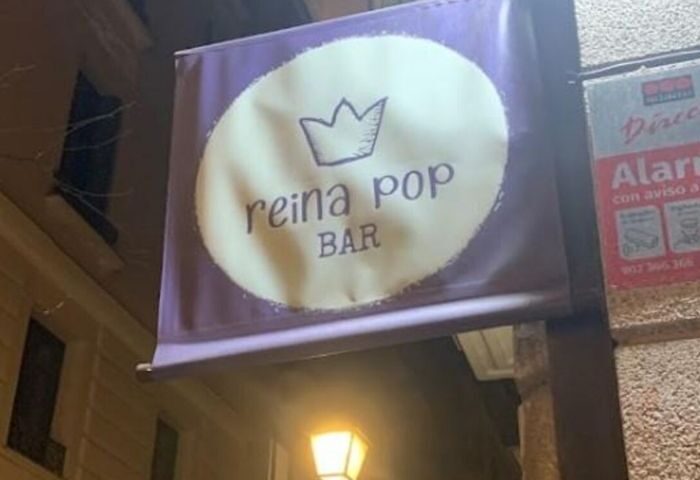 Reina Pop Bar sign in Madrid. Popular gay bar with a crown logo. Gay travel destination for nightlife. Madrid's LGBTQ+ scene.