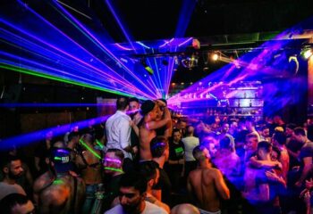 Gay Replay Party in Vienna: Crowd of men dancing with laser lights. Gay nightlife, travel advice, and party scene.