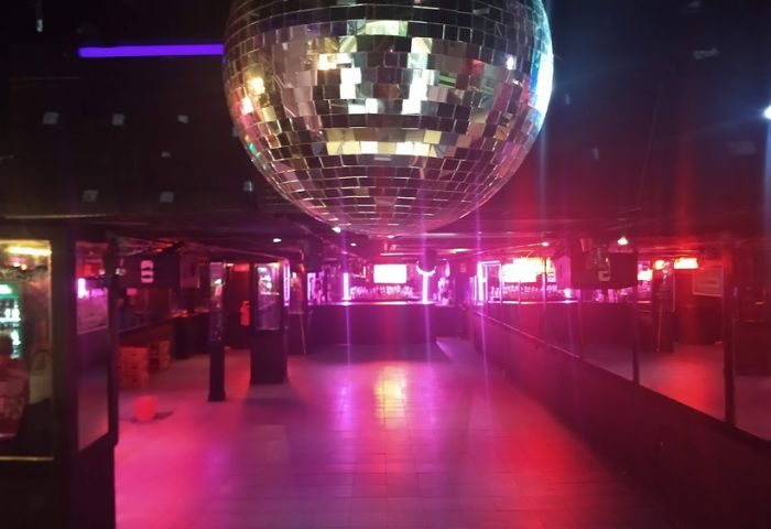 Rico Club gay bar in Mexico. Interior shot of disco ball, dance floor, bar area. Gay travel guide.