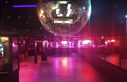 Rico Club gay bar in Mexico. Interior shot of disco ball, dance floor, bar area. Gay travel guide.