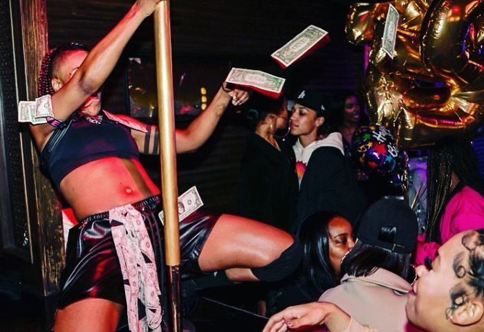 Robertson Nightclub dancing: A diverse crowd enjoys a lively night. A dancer performs as money flies, couples kiss, and balloons decorate the scene.