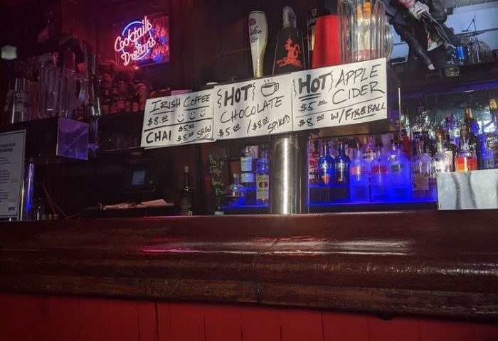 Rockbar NYC menu board: Irish coffee, chai, hot chocolate, apple cider prices. Gay bar in New York City, travel advice for gay men.