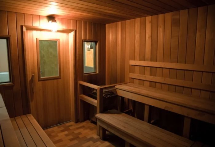Interior of Russian and Turkish Baths in New York. Wood-paneled sauna with benches. A gay men's travel destination for relaxation.