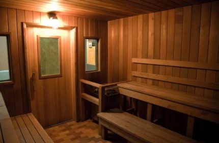 Interior of Russian and Turkish Baths in New York. Wood-paneled sauna with benches. A gay men's travel destination for relaxation.