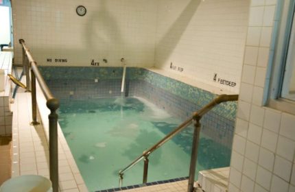 Indoor pool at Russian & Turkish Baths in New York. 4 feet deep, tiled walls, handrails. A gay travel destination for relaxation.