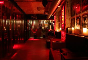 SLM Copenhagen interior. Red-lit gay cruise club with dark room, hammocks, and lounge area. Gay travel advice in Copenhagen.