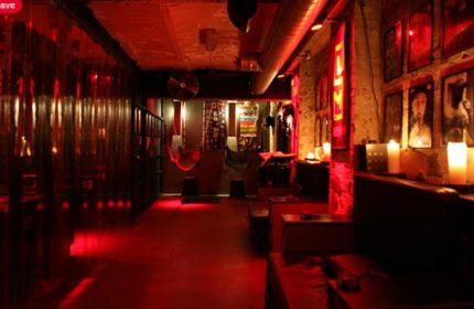 SLM Copenhagen interior. Red-lit gay cruise club with dark room, hammocks, and lounge area. Gay travel advice in Copenhagen.