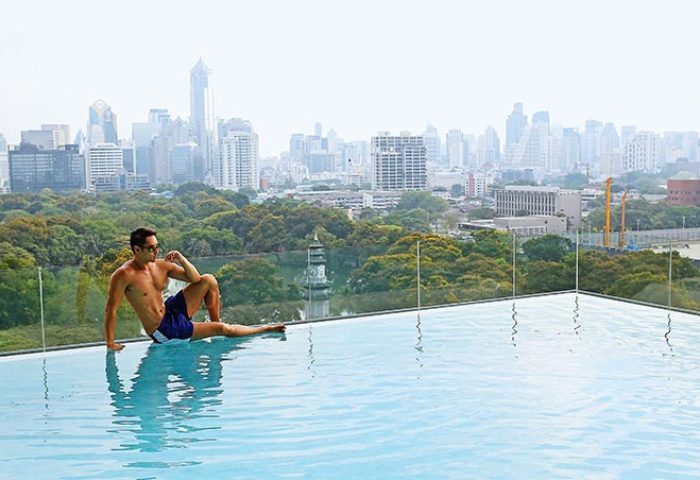 Gay traveler at SO Sofitel Bangkok's popular rooftop infinity pool. Enjoying the city view, a top gay-friendly hotel. #GayTravel #Bangkok