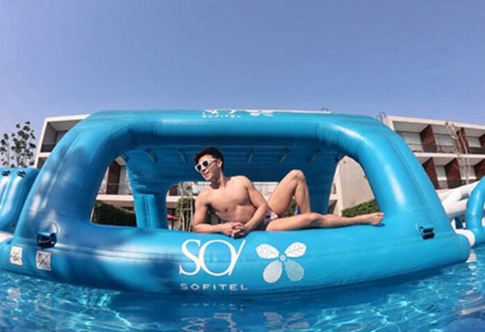 SO/ Sofitel Hua Hin: Gay traveler lounging on a Witbit inflatable in the pool. Perfect for gay men's travel advice and relaxation.