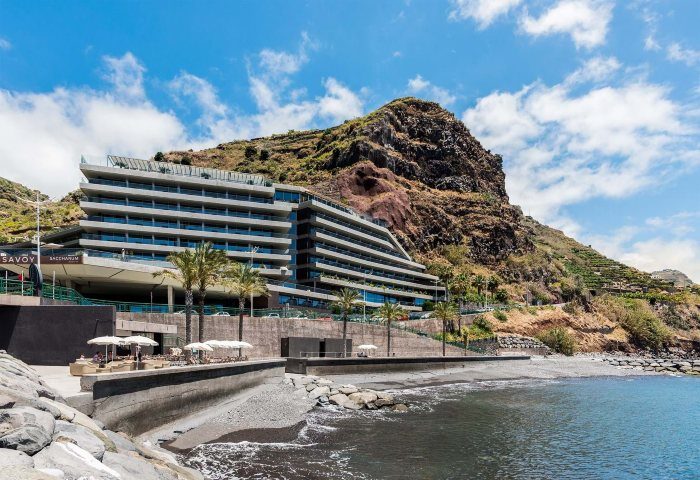 Saccharum Hotel, gay-friendly beachfront hotel in Madeira, Portugal. Modern architecture against a mountain backdrop, near the beach.