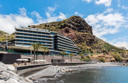 Saccharum Hotel, gay-friendly beachfront hotel in Madeira, Portugal. Modern architecture against a mountain backdrop, near the beach.