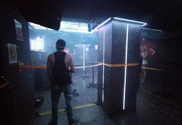 Inside Sala Republik Club, a gay club in Madrid. A man stands in the nightclub with modern lighting and a dance floor. Gay nightlife.