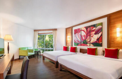 Samed Pavilion Resort room. Best gay hotel in Koh Samet for gay groups near nightlife. Twin beds, sofa, and floral art. Thailand travel.