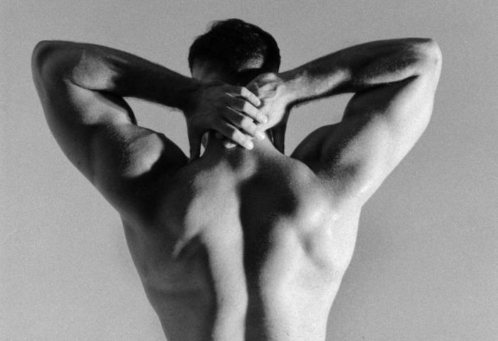 Sasha Bloom by Sasha massage experience: Muscular gay man's back in black and white. Ideal for gay travel, health, and wellness content.