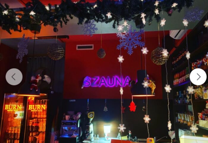 Budapest's Sauna 69 bar area, decorated for Christmas. The gay sauna's bar has drinks, coffee, & festive lights for a fun atmosphere.