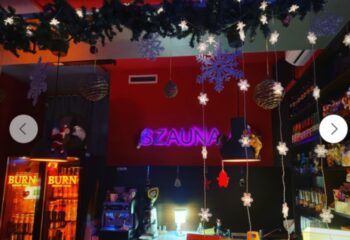 Budapest's Sauna 69 bar area, decorated for Christmas. The gay sauna's bar has drinks, coffee, & festive lights for a fun atmosphere.
