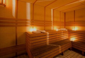 Inside Casanova gay sauna in Barcelona: Wooden benches, warm lighting, and towels. A relaxing space for gay men's travel.