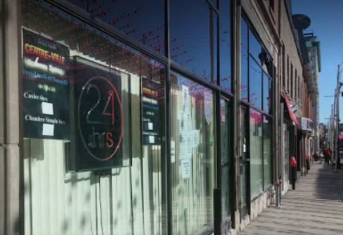 Montreal gay sauna in Centre-Ville. The glass front of the building has a sign that says 24 hrs. Cruising spot for gay men in Montreal.