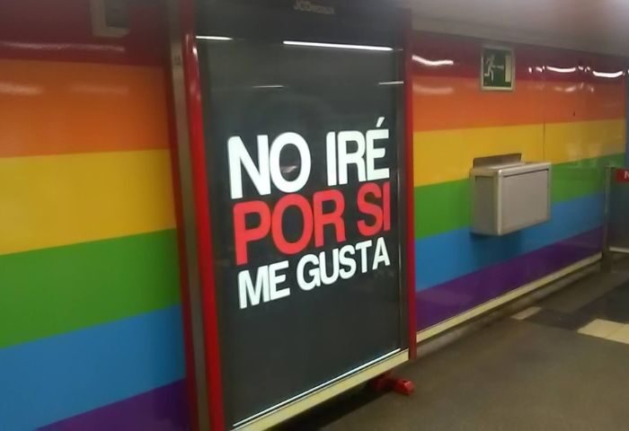 Madrid's Lavapies gay sauna features a rainbow wall. An ad reads No iré por si me gusta (I won't go in case I like it). Gay travel.