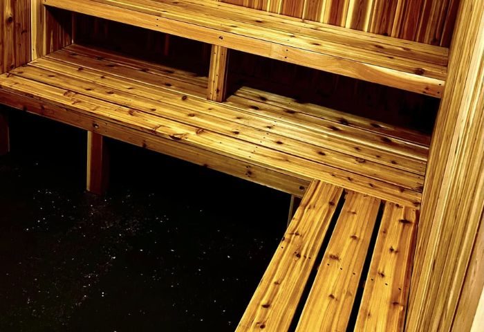 Interior of a sauna in Montreal. Wooden benches and walls create a warm, inviting space for relaxation and wellness. Gay travel advice.