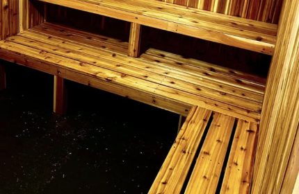 Interior of a sauna in Montreal. Wooden benches and walls create a warm, inviting space for relaxation and wellness. Gay travel advice.