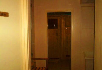 Saunabar London Portsea: Interior view of the gay sauna. Wooden sauna room visible through doorway. Gay travel advice for London gay saunas.