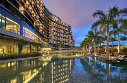 Savoy Palace Madeira gay-friendly hotel view. Modern architecture, pool, palm trees. Luxury travel destination for gay men in Funchal, Portugal.