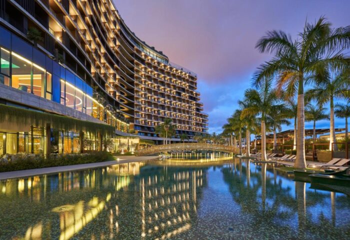 Savoy Palace Madeira gay-friendly hotel view. Modern architecture, pool, palm trees. Luxury travel destination for gay men in Funchal, Portugal.