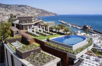 Savoy Palace Madeira Hotel rooftop pool and sun loungers with ocean view. Gay travel luxury resort in Funchal, Madeira, Portugal.