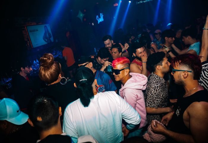 Scarlet Bar gay party in Chicago. Crowd of diverse men dancing, socializing, and enjoying the nightlife at a LGBTQ+ event.