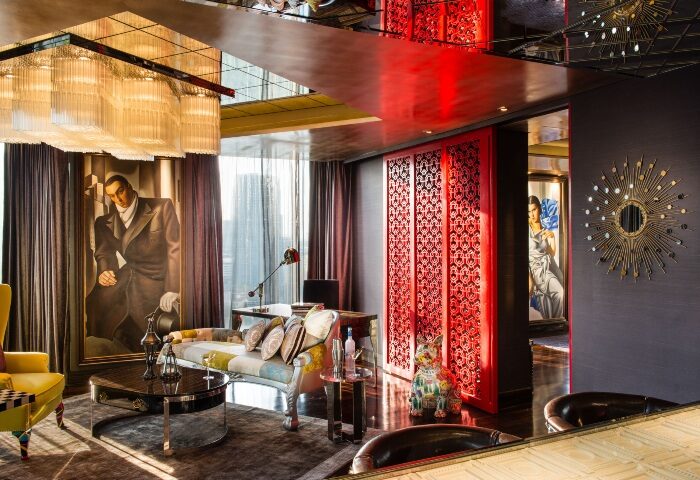 Hotel Indigo Bangkok Wireless Road sexy room decor. Gay hotels Bangkok. Stylish interior with art, red accents, & modern design elements.