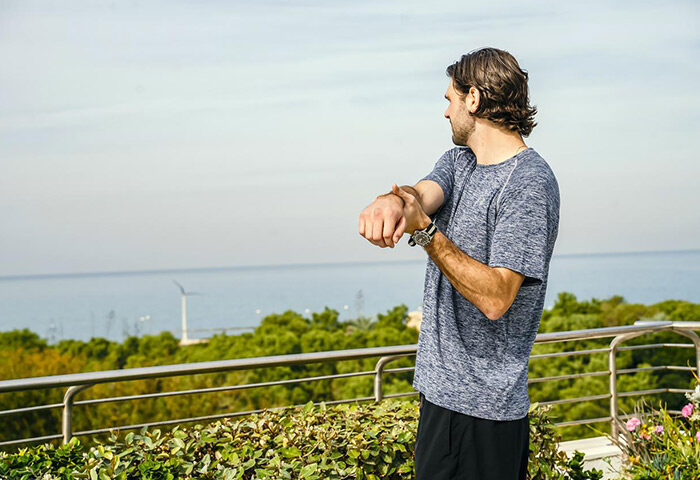 Gay man stretching at Shalom Hotel & Relax, an Atlas Boutique Hotel in Tel Aviv. Most booked gay hotel. Sea view.