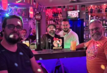 Gay men at Shelter Bar, Lisboa. Friends at a gay bar in Lisbon, Portugal. Bar scene with drinks and good times. Gay travel.