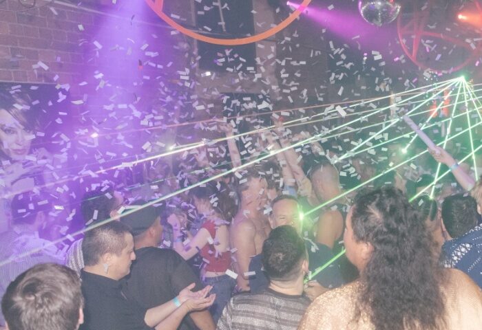Sircuit Bar Melbourne: A lively gay club scene with confetti, lasers, and dancing patrons. Nightlife and gay travel in Australia.