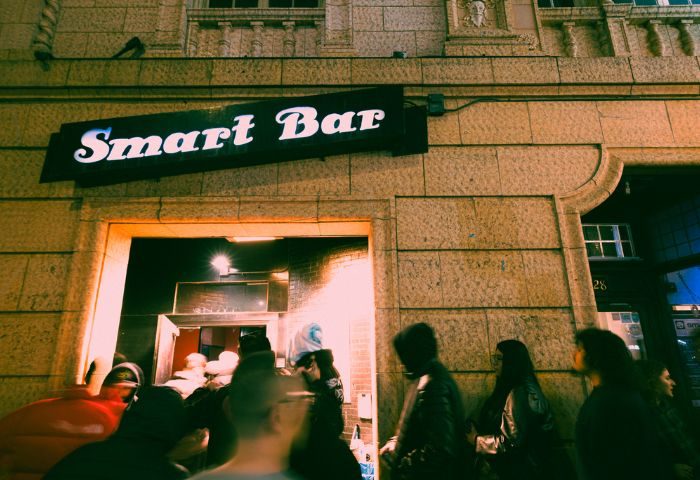 Smartbar entrance at a gay party in Chicago. People are queuing to enter the bar. Nightlife scene, gay travel advice.
